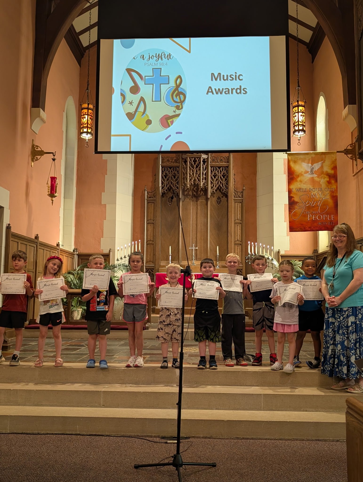 A Zion Lutheran class proudly holding their music awards in the church sanctuary